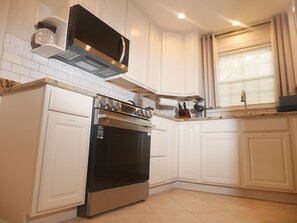 A kitchen with white cabinetry, a stainless steel oven, and a microwave above it. - Quiet Forest Hill/Restaurant/James River/Byrd Park (City of Richmond)