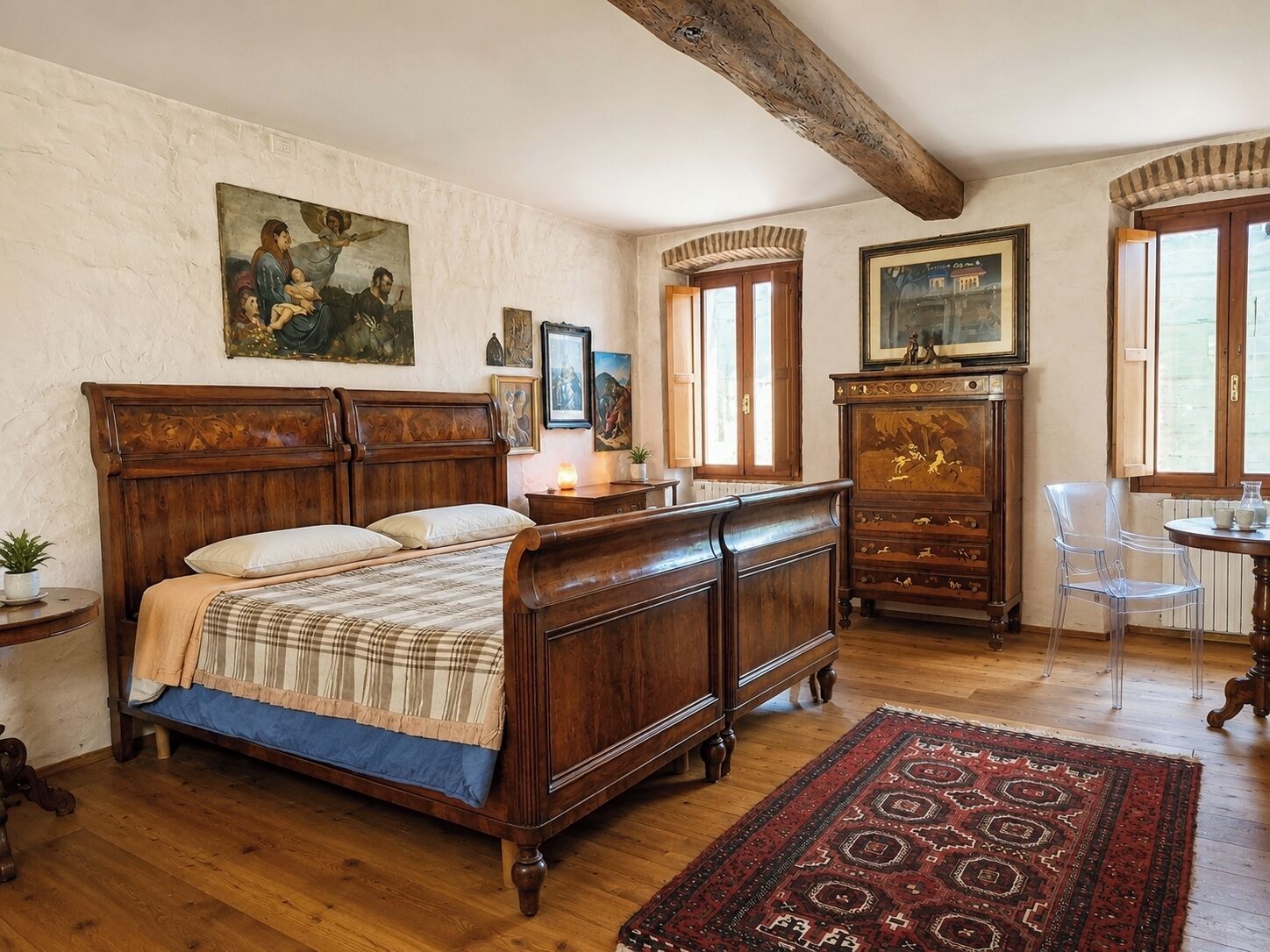 A bedroom with a wooden bed, a dresser, a chair, and a painting on the wall.