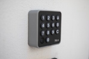 A keypad lock on a wall.