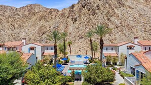 A resort with multiple villas, a swimming pool, and palm trees. - LV319 Luxury 3BR Legacy Villas Steps to Pool & Spa (La Quinta)