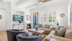 A living room with a fireplace, a television, and a sofa. - LV319 Luxury 3BR Legacy Villas Steps to Pool & Spa (La Quinta)
