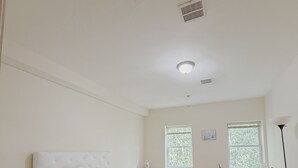 A bedroom with a bed, a desk, a chair, a nightstand, and a lamp. - Beautiful Private room in a  2-bedroom apartment in vibrant Jersey City (Jersey City)
