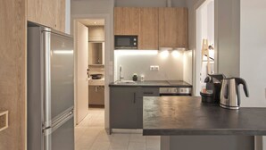 Eine moderne Küche mit einem Edelstahl-Kühlschrank, einer Mikrowelle, einem Herd und einer Kaffeemaschine.