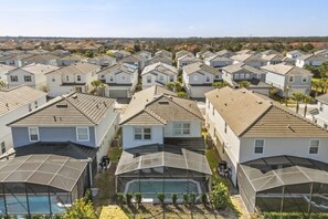 A residential area with multiple houses, each with a covered outdoor swimming pool. - 5 BD/ 4 BA/ Solterra (7247OL) (Davenport)