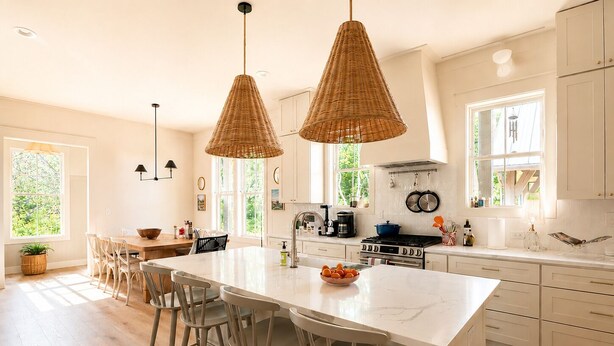 A spacious kitchen with a large island, white cabinetry, and hanging wicker pendant lights. - Rabbit Ridge New Designer Cottage Screened Porch + Wood Fireplace | EV Charger (Cashiers)