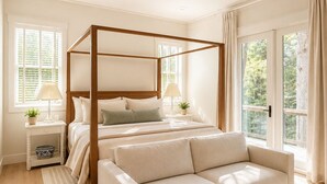 A bedroom with a four-poster bed, a sofa, a ceiling fan, and large windows. - Rabbit Ridge New Designer Cottage Screened Porch + Wood Fireplace | EV Charger (Cashiers)
