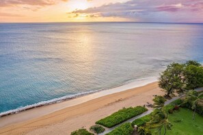 A beach with a clear view of the ocean and a path leading to the shore. - 2BR West Maui condo with pool, patio, AC, and full kitchen -ICC 4 (Lahaina)
