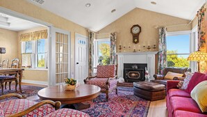 A spacious living room with a fireplace, patterned rugs, and comfortable seating. - Vineyard Estate & Water Tower | Hot Tub | Views (Sebastopol)