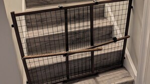 A staircase with wooden steps and a metal safety railing.