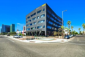 A modern building with a flat roof, multiple windows, and a sign indicating the address 1030. - The Neon Circuit Loft (Phoenix)