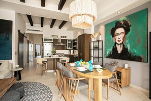 A modern dining area with a wooden table, chairs, and a chandelier. - Beautiful 2 bed 2 bath
Penthouse in the heart of the Romantic Zone (Puerto Vallarta)