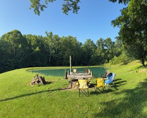 A lakeside campsite with a dock, chairs, and a fire pit. - Welcome Dona Catalina Farm House a quiet and spacious home in Tell City IN. (Tell City)