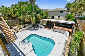 A backyard with a swimming pool, a wooden deck, and a covered patio area. - 2BR, 2BA Beach House w/ Private Pool 11-Minute Walk to Shoreline (Panama City Beach)
