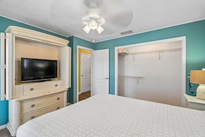 A bedroom with a bed, a TV on a dresser, a closet, and a ceiling fan. - 2BR, 2BA Beach House w/ Private Pool 11-Minute Walk to Shoreline (Panama City Beach)