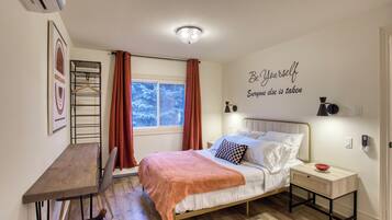 A bedroom with a bed, bedside table, and a wall-mounted shelf.