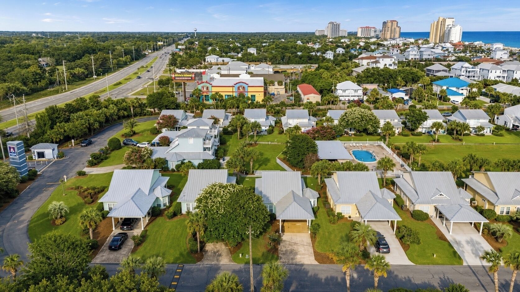 A residential area with houses, a swimming pool, and a road.
