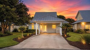 A two-story house with a covered front porch and a driveway leading to the entrance. - Mainsail Miramar Beach | Coastal Cottage | Sleep 9 (Miramar Beach)
