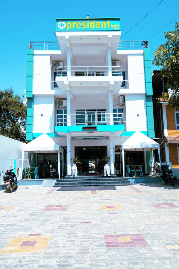 A hotel with a sign reading 'President Hotel' and a sign indicating 'Room Available'. - President Hotel Lumbini (Lumbini)