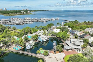 A marina with boats, a dock, and residential buildings. - BayviewPalms - Sandestin 2BR Bayview + Golf Cart (Miramar Beach)