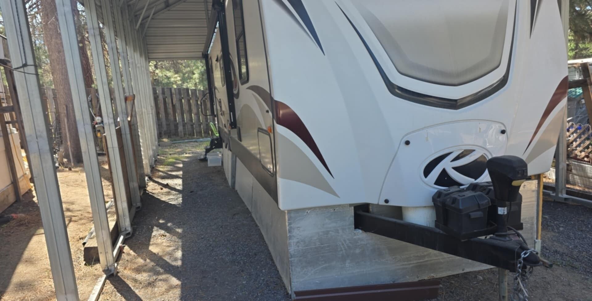 A recreational vehicle with a covered storage area and a mounted air compressor.