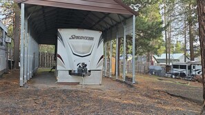 A covered RV parking area with a white RV named 'SPRINTER' parked inside.