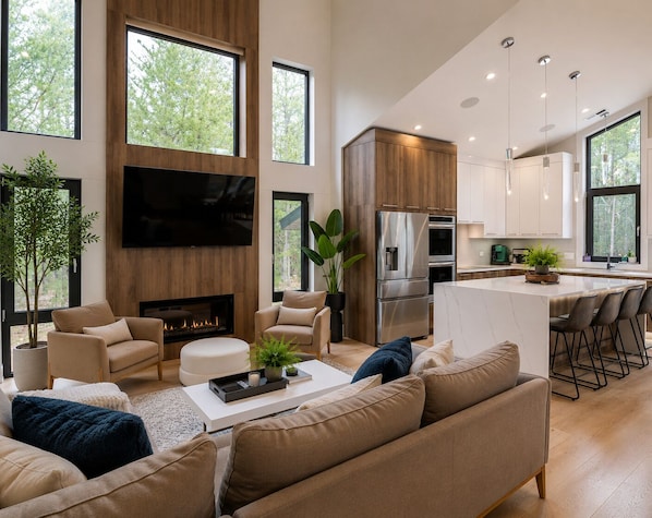 A modern living room with a fireplace, sofa, and TV.