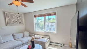 A modern living room with a sofa, coffee table, and a television.