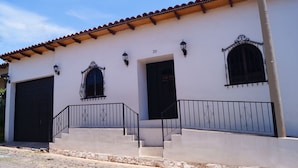 A building with a white facade, a red-tiled roof, and a number '30' on the wall. - La Casona Suchitoto  (Suchitoto)