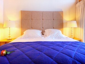 A hotel room with a large bed, two bedside lamps, and a headboard. - Teychenne Mungo by Interhome (Thyon-Les Collons)