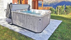 A hot tub in a wooden outdoor setting with a mountain view. - Teychenne Mungo by Interhome (Thyon-Les Collons)