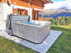 A hot tub in a wooden outdoor setting with a mountain view. - Teychenne Mungo by Interhome (Thyon-Les Collons)