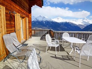 A wooden cabin with a balcony, outdoor seating, and a mountain view. - Chalet Krokus by Interhome (Thyon-Les Collons)