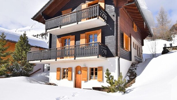 A multi-story wooden chalet with balconies, set in a snowy landscape. - Chalet Altitude 1900 by Interhome (Thyon-Les Collons)