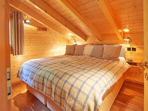 A cozy wooden cabin bedroom with a bed, curtains, and a nightstand. - Roche des 4 Vallées by Interhome (Hérémence)