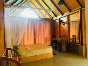 A wooden cabin room with a bed, a table, and a chair. - Happy Sky Ella (Ella)