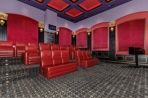 A theater with red seating, black patterned carpet, and gold accents on the ceiling. - Cozy, stylish and vibrant Downtown Los Angeles home available for Sept 1-30 (Los Angeles)