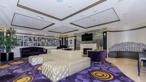 A spacious living room with a large sectional sofa, a fireplace, and a television mounted on the wall. - Cozy, stylish and vibrant Downtown Los Angeles home available for Sept 1-30 (Los Angeles)