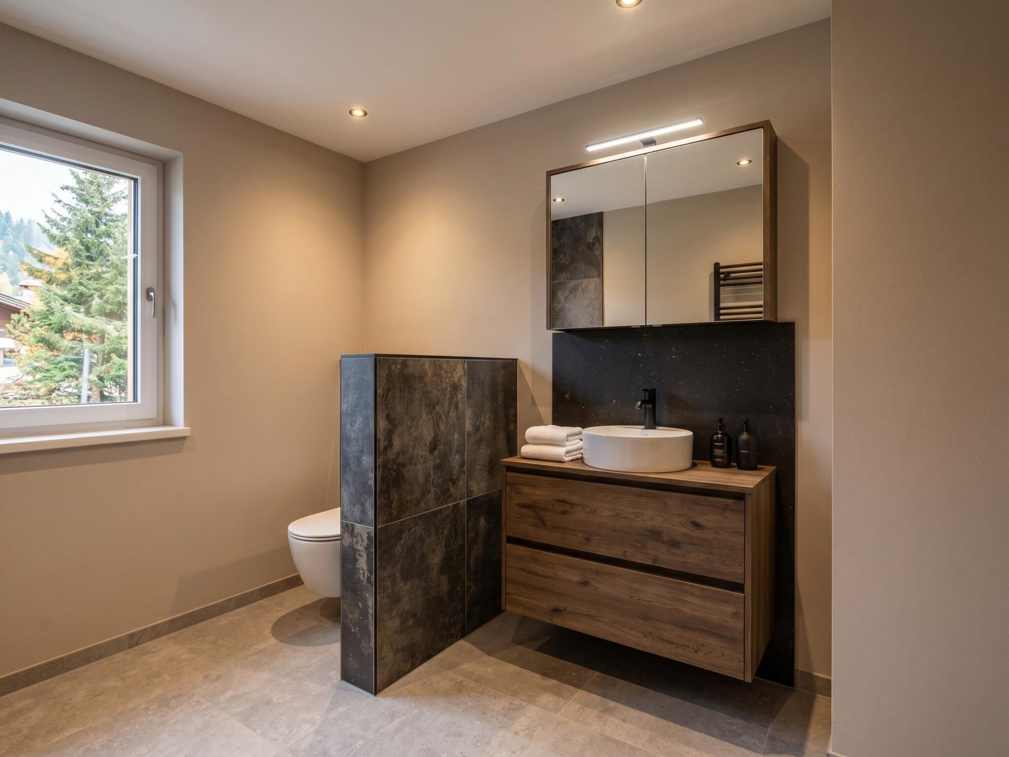 A modern bathroom with a toilet, a vanity with a sink, and a mirror.