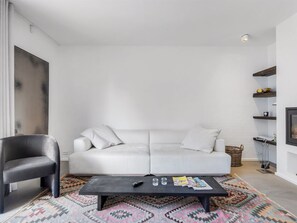 A modern living room with a grey sofa, a black armchair, a coffee table, and a patterned rug. - "Ehlin" - 900m from the sea by Interhome (Skagen)