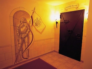 A hallway with a door labeled 'Schloß-Sauna' and a wall-mounted emblem. - Gratlspitz by Interhome (Auffach)