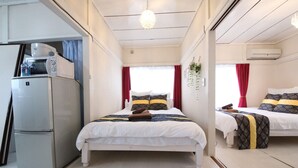 A bedroom with a bed, a refrigerator, and a window with curtains. - RESIDENTIALHOTELDAIICHI-H OKUBO Room.2C (Tokyo)