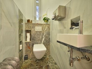 A bathroom with a toilet, sink, and marble flooring. - Apartment Dalia by Interhome (Smichov Kosire Jinonice)