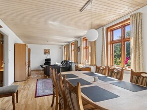 A spacious room with a large table, chairs, a sofa, and a wardrobe. - "Helge" - 10km from the sea by Interhome (Rønne)