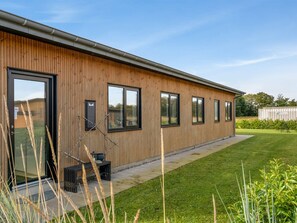 A modern building with a wooden exterior, large windows, and a grassy yard. - "Constance" - 900m from the sea by Interhome (Hadsund)