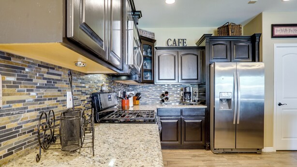 A kitchen with granite countertops, stainless steel appliances, and a backsplash of multicolored tiles. - Santa Teresa Retreat w/ Outdoor Fireplace (Santa Teresa)