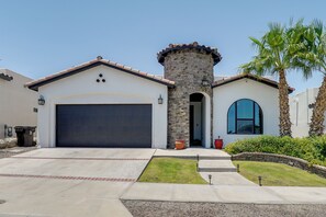 A residential house with a garage, a stone tower, and a palm tree. - Santa Teresa Retreat w/ Outdoor Fireplace (Santa Teresa)