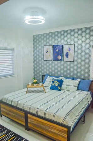 A bedroom with a bed, a bedside table, and a wall with a geometric pattern. - Modern Luxury Villa - Vista Cana  Private Pool- Golf - Beach Access (Punta Cana)