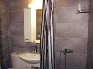 A bathroom with a sink, mirror, and shower curtain. - Amazing Studio 11 minutes wak from Center (Thessaloniki)