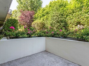 A landscaped garden area with a variety of shrubs and flowering plants. - Annabel by Interhome (Houlgate)
