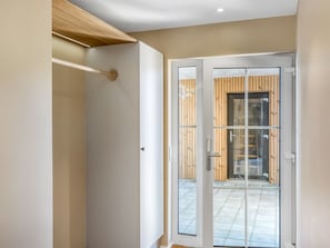 A modern interior with a sliding glass door leading to an outdoor area with a tiled floor. - "Indra" - 800m from the sea by Interhome (Løkken)